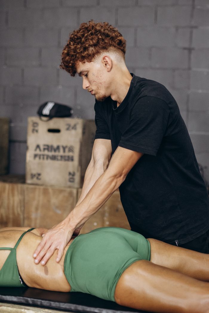 Therapist performing myofascial release on a reclining client for recovery and rehabilitation.